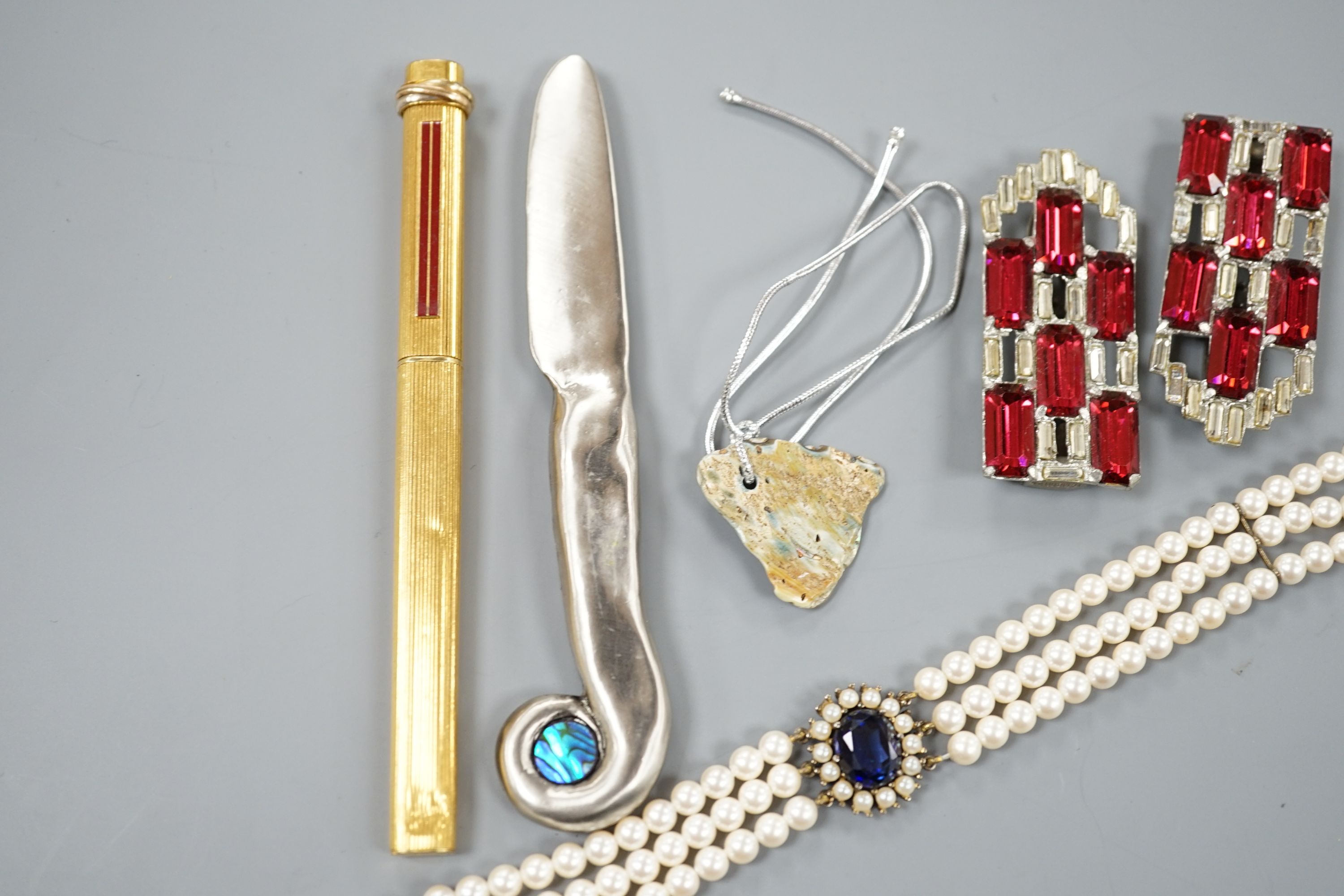 A Cartier gold plated end red enamel ball point pen and minor costume jewellery.